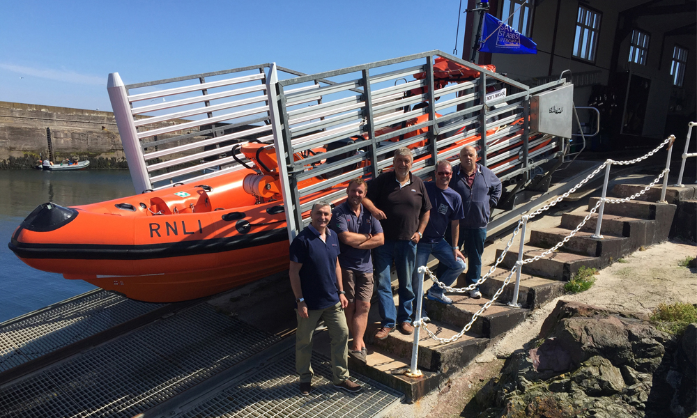BSAC - Eugene Farrell with St Abbs team at Lifeboat Station with RIB