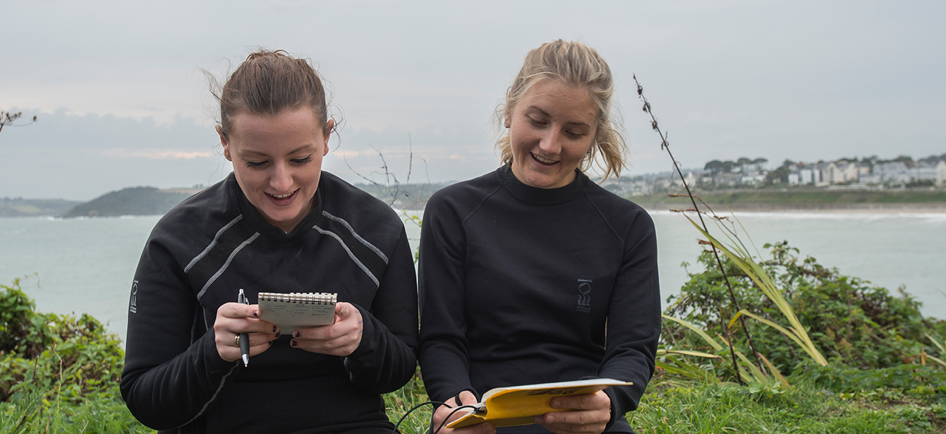 Two female divers plan before a dive