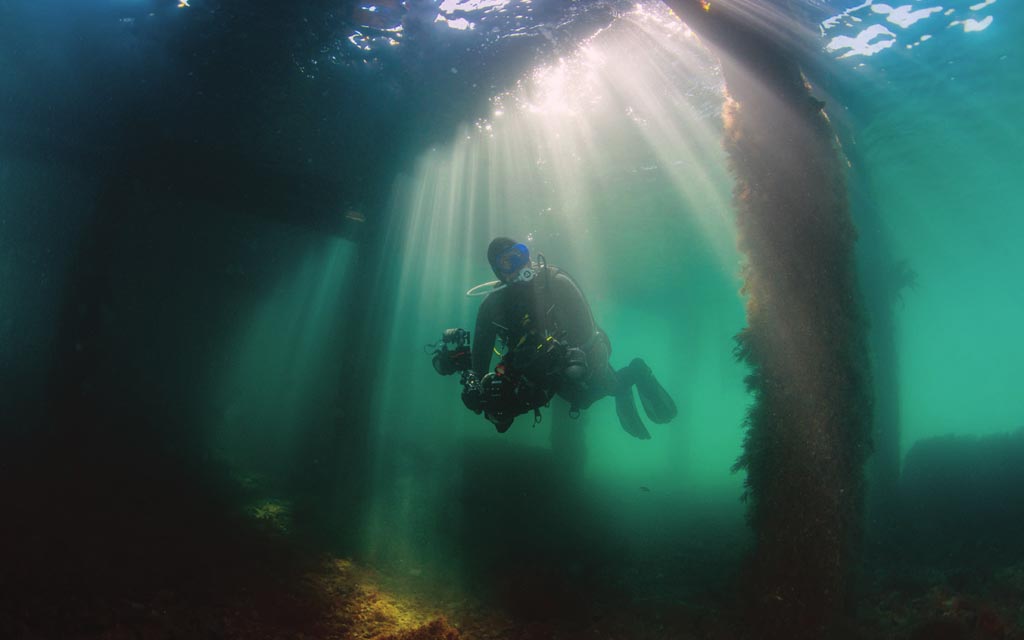 Diver underwater with video equipment