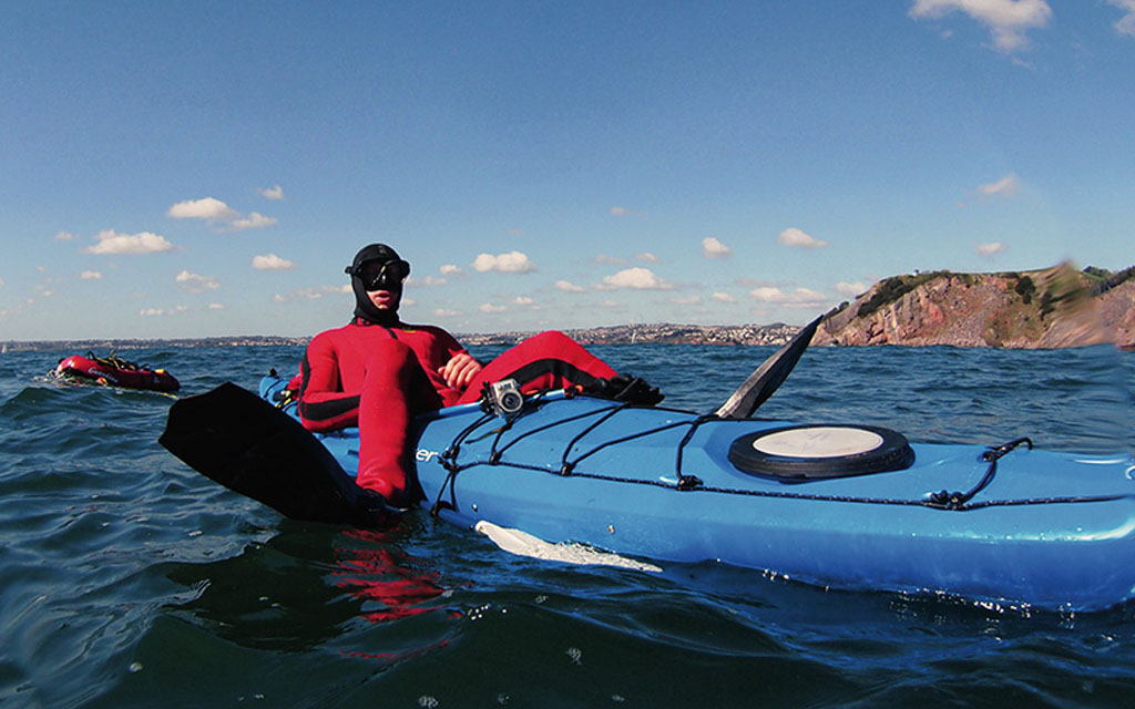 Andy off for a snorkel-by-kayak in his uncomfortably tight wetsuit.
