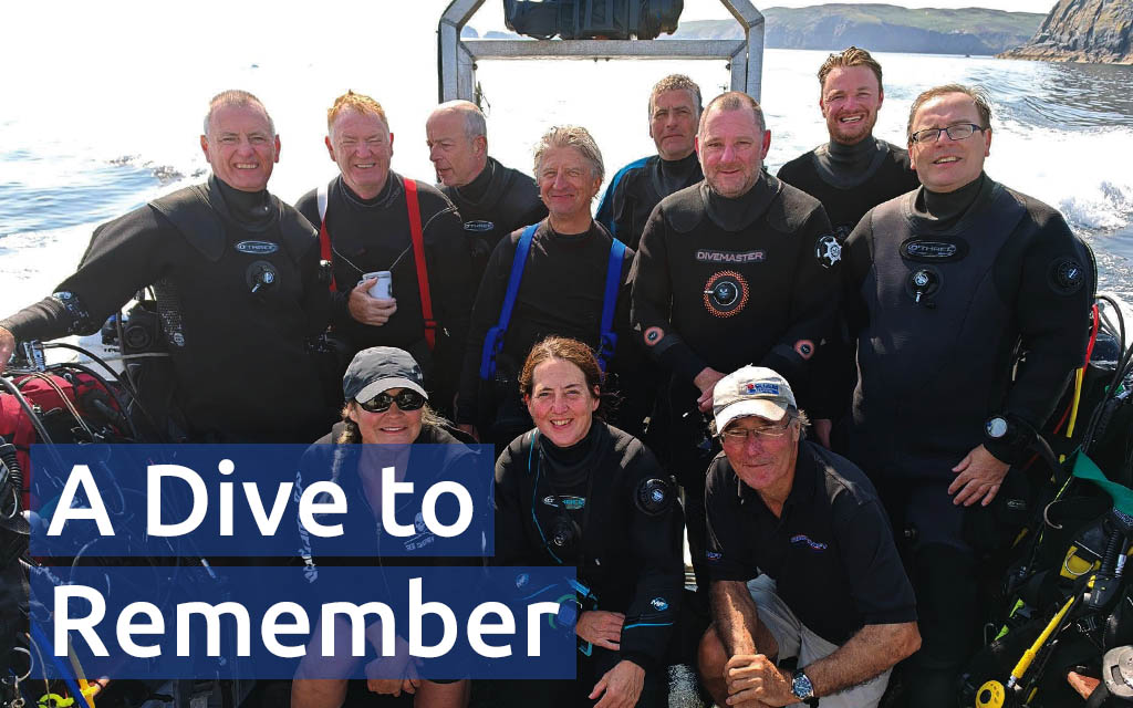David (back row, far right) and fellow members of Carlisle SAC posing on their boat, dive kits ready to go