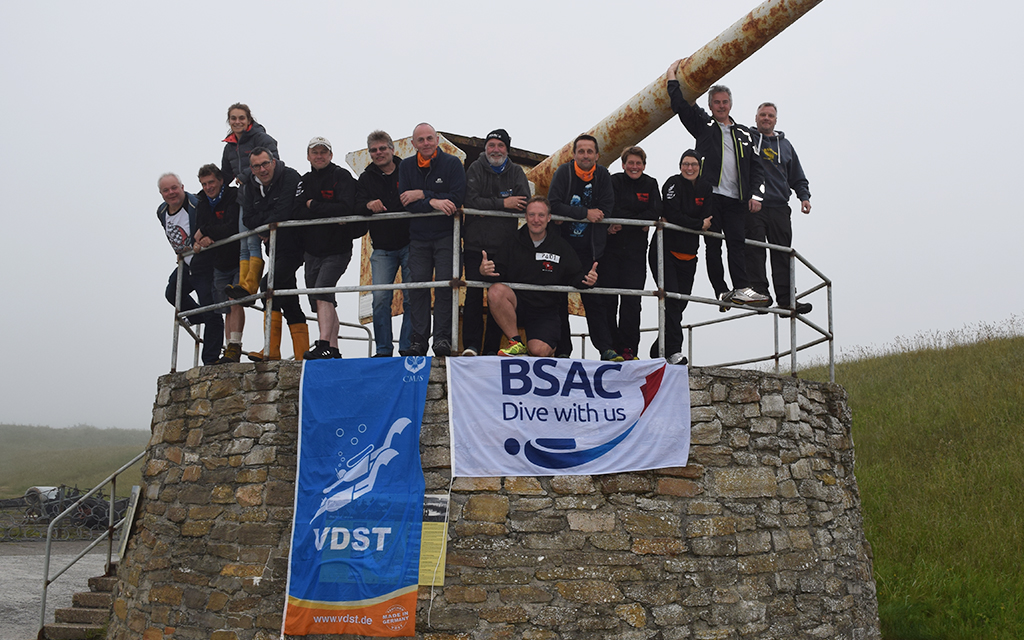 The BSAC and VDST team topside, flying the flags of their organisations before the dive.