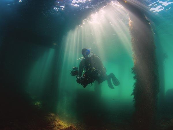 Diver underwater with video equipment