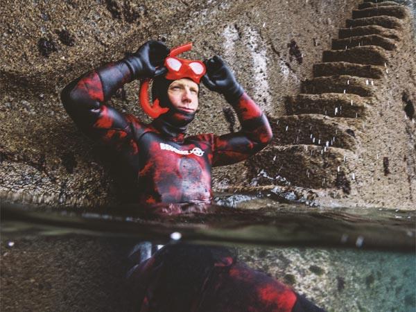 Andy Torbet half submerged, in snorkelling gear, ready for a dive