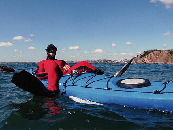 Andy off for a snorkel-by-kayak in his uncomfortably tight wetsuit. 