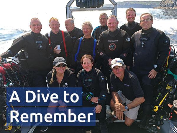 David (back row, far right) and fellow members of Carlisle SAC posing on their boat, dive kits ready to go
