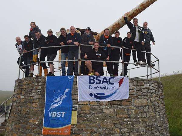 The BSAC and VDST team topside, flying the flags of their organisations before the dive.