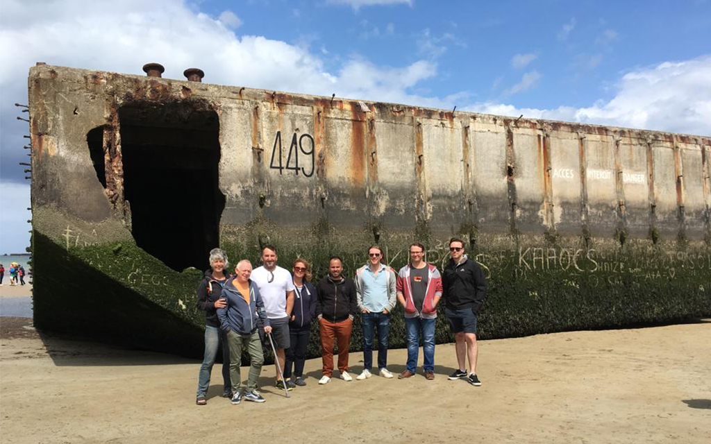 Group in front of wreck on beach