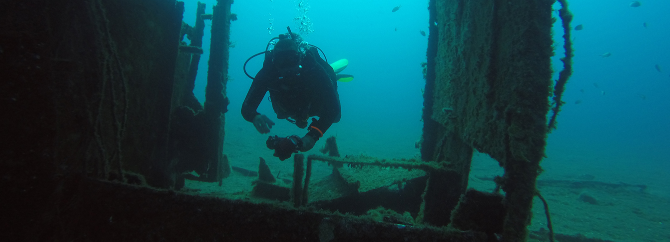 diver swimming through a wreck overseas