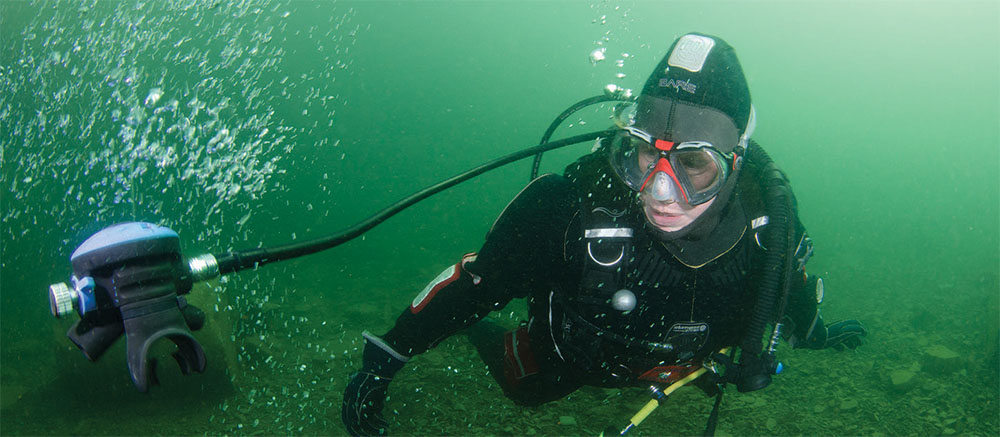 Diver underwater with regulator detached