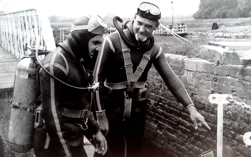 B&W photo of two male divers