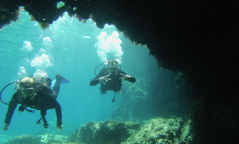 Divers entering cave