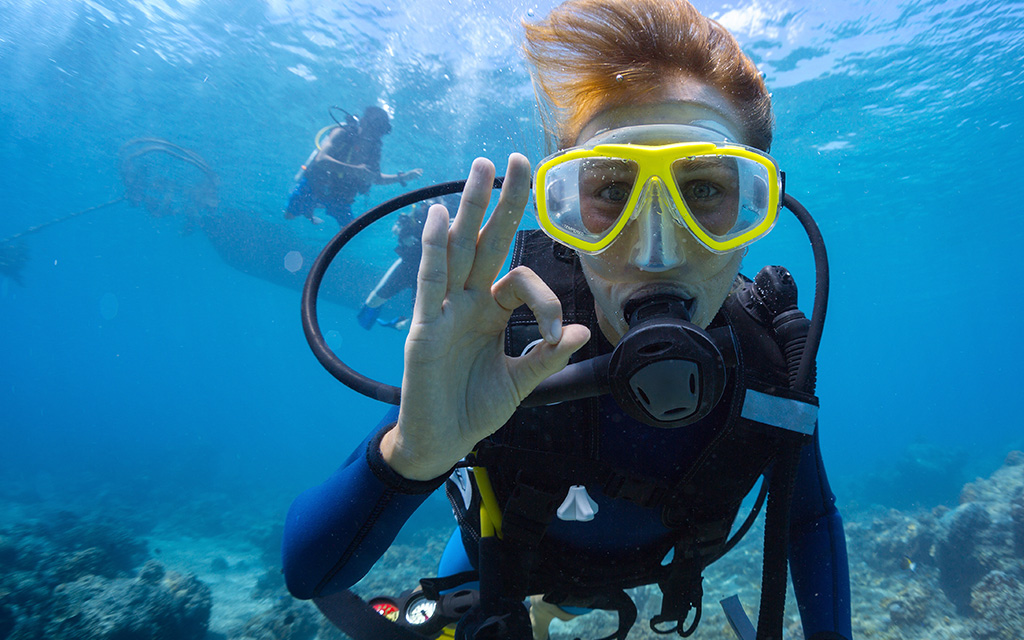 Scuba diver signalling okay whilst diving overseas