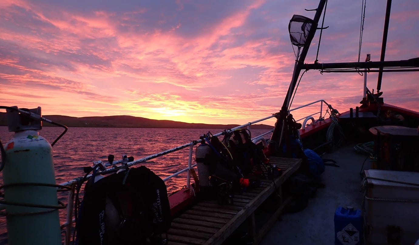 Sunset over a Scapa dive boat