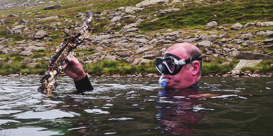 Snorkeller Ian Tannock finds some aircraft wreckage in a mountain lake, replacing it where it had been found.