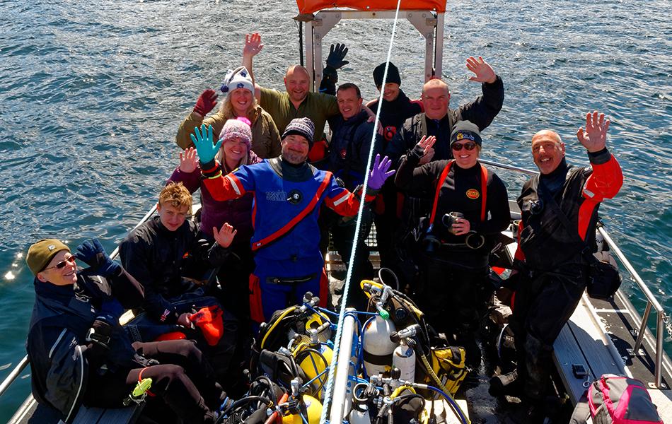 Barnsley BSAC Divers on a boat with their hands in the air